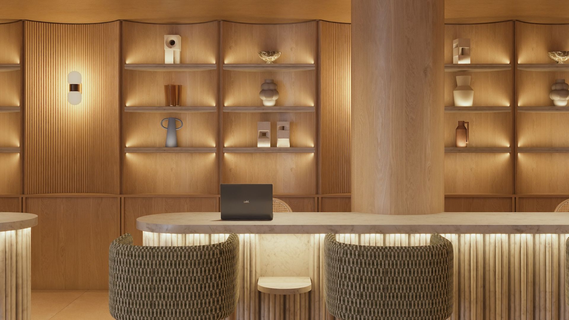 A modern interior with a wooden wall, shelves with decorative items, a laptop on a table, and two upholstered chairs.