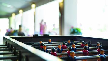 A foosball table with players in blue and pink uniforms.