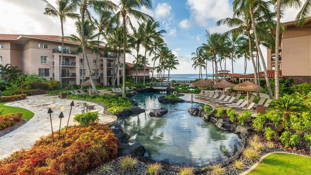 A resort with a pool, palm trees, and a view of the ocean. - Marriott's Waiohai Beach Club (Koloa)