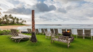 A beachside lounge with lounge chairs and a fire pit, overlooking the ocean. - Marriott's Waiohai Beach Club (Koloa)