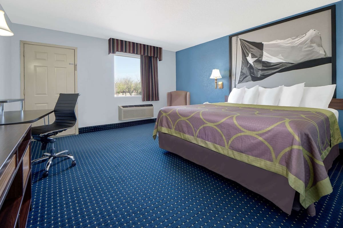 Escritorio, cortinas blackout y tabla de planchar con plancha