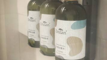 Three Erulan shampoo bottles mounted on a wall.