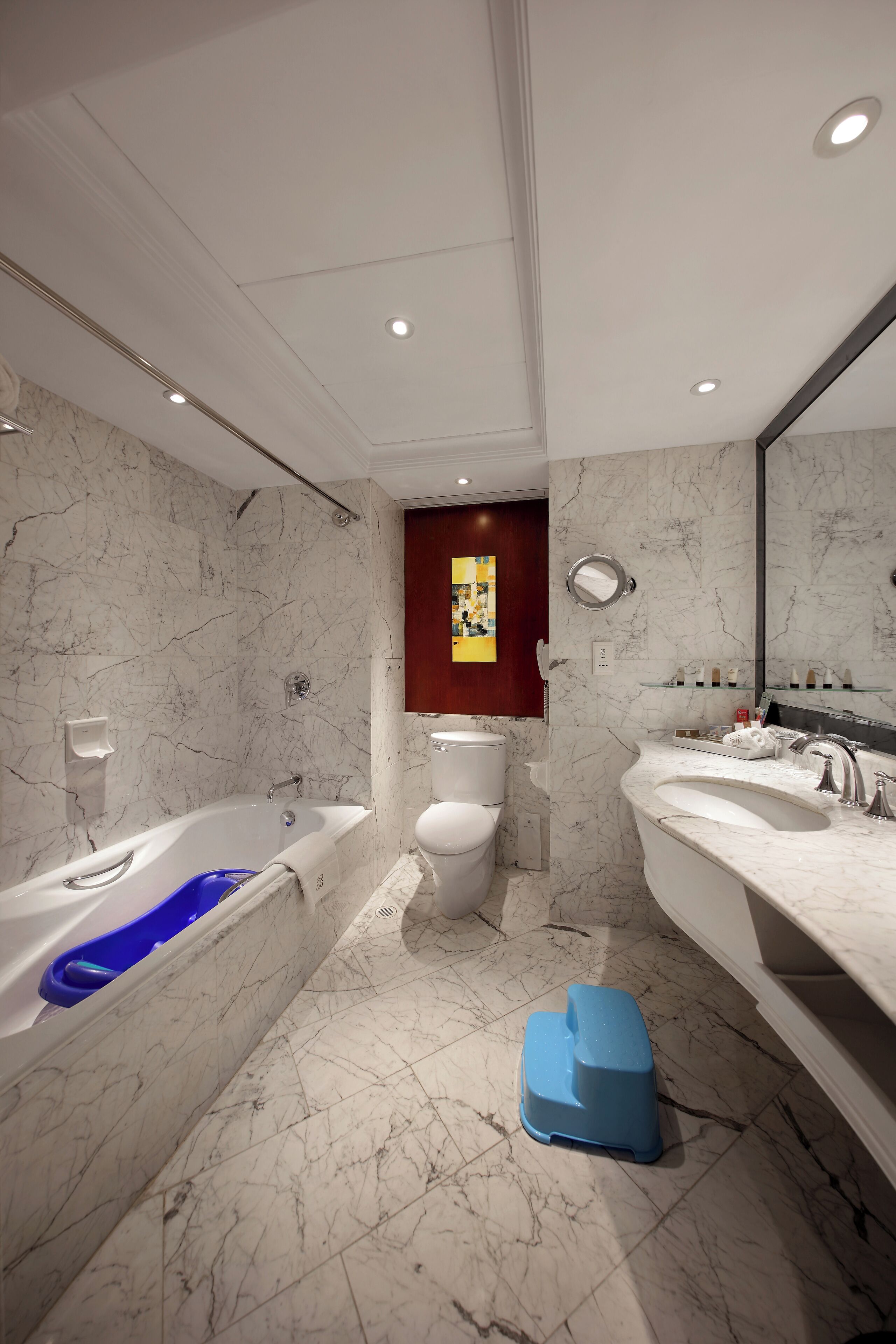 A modern bathroom with a bathtub, toilet, and sink.
