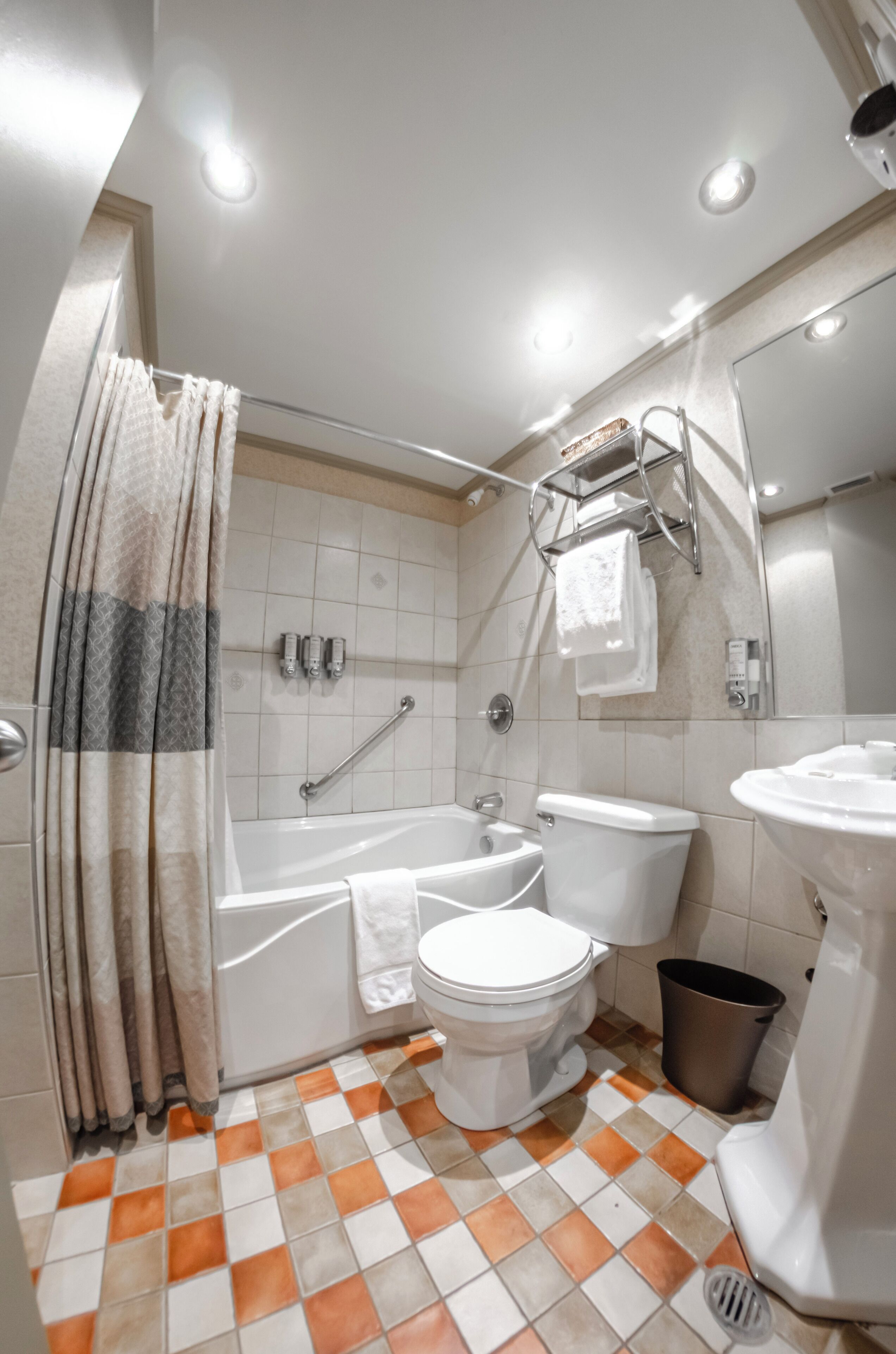 A bathroom with a bathtub, toilet, and sink.