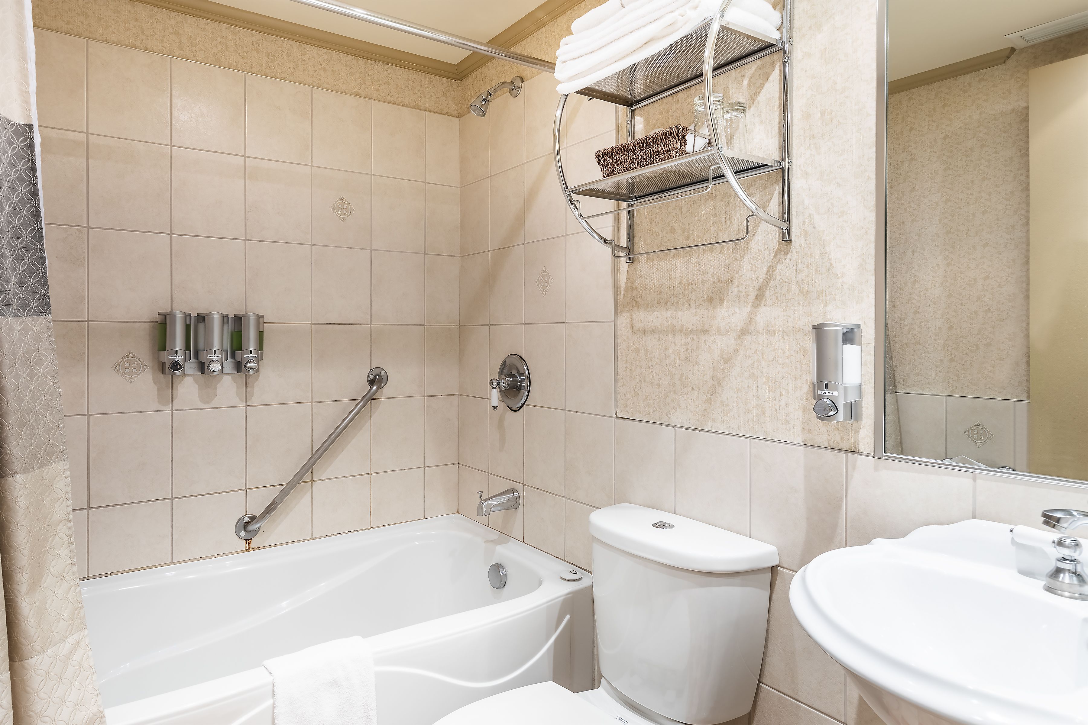 designer toiletries, hair dryer, towels