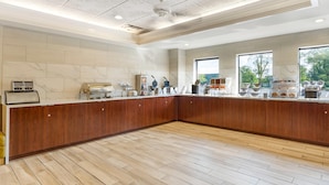A spacious kitchen with a wooden countertop, marble backsplash, and a ceiling with intricate patterns. - Comfort Inn & Suites LaVale - Cumberland (Cumberland)