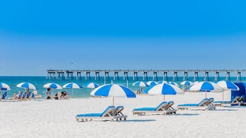 On the beach, white sand, beach cabanas, beach umbrellas