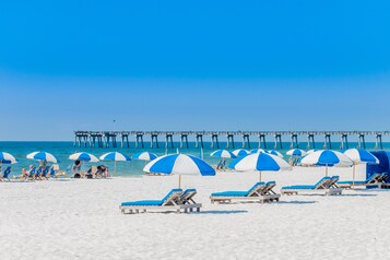 On the beach, white sand, beach cabanas, beach umbrellas