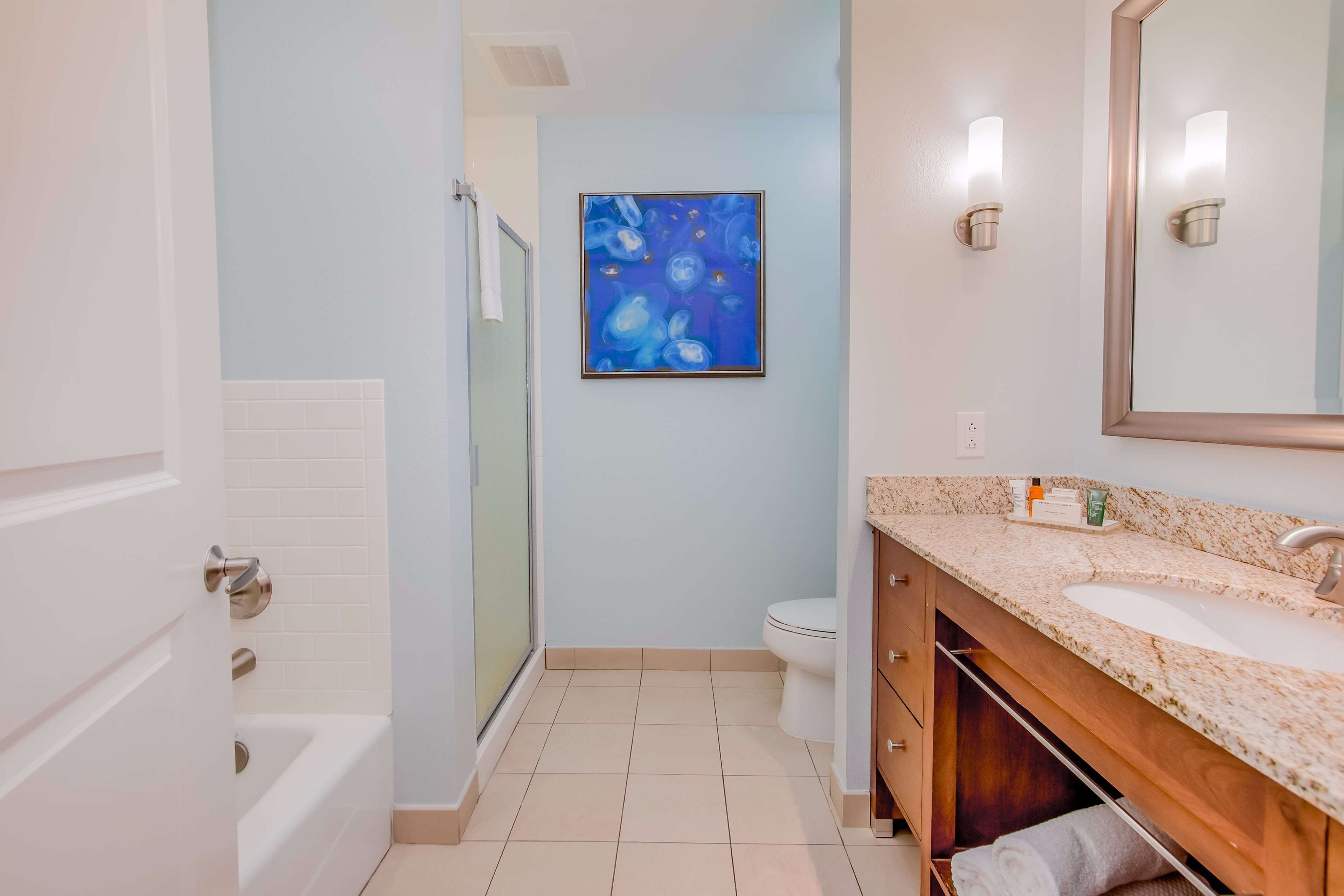 A bathroom with a bathtub, a toilet, a sink, and a shower.
