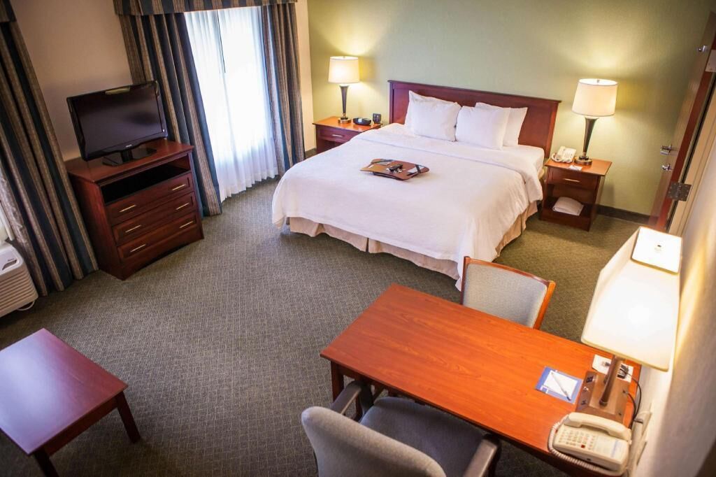 Hypo-allergenic bedding, desk, laptop workspace, blackout curtains
