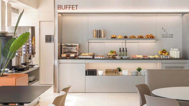A modern buffet area with a variety of food items displayed on shelves and counters. - B&B Hotel Granada Estación (Granada)