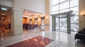 A spacious lobby with a marble floor, a reception desk, and a staircase leading to upper floors. - Rixwell Viru Square Hotel (Tallinn)