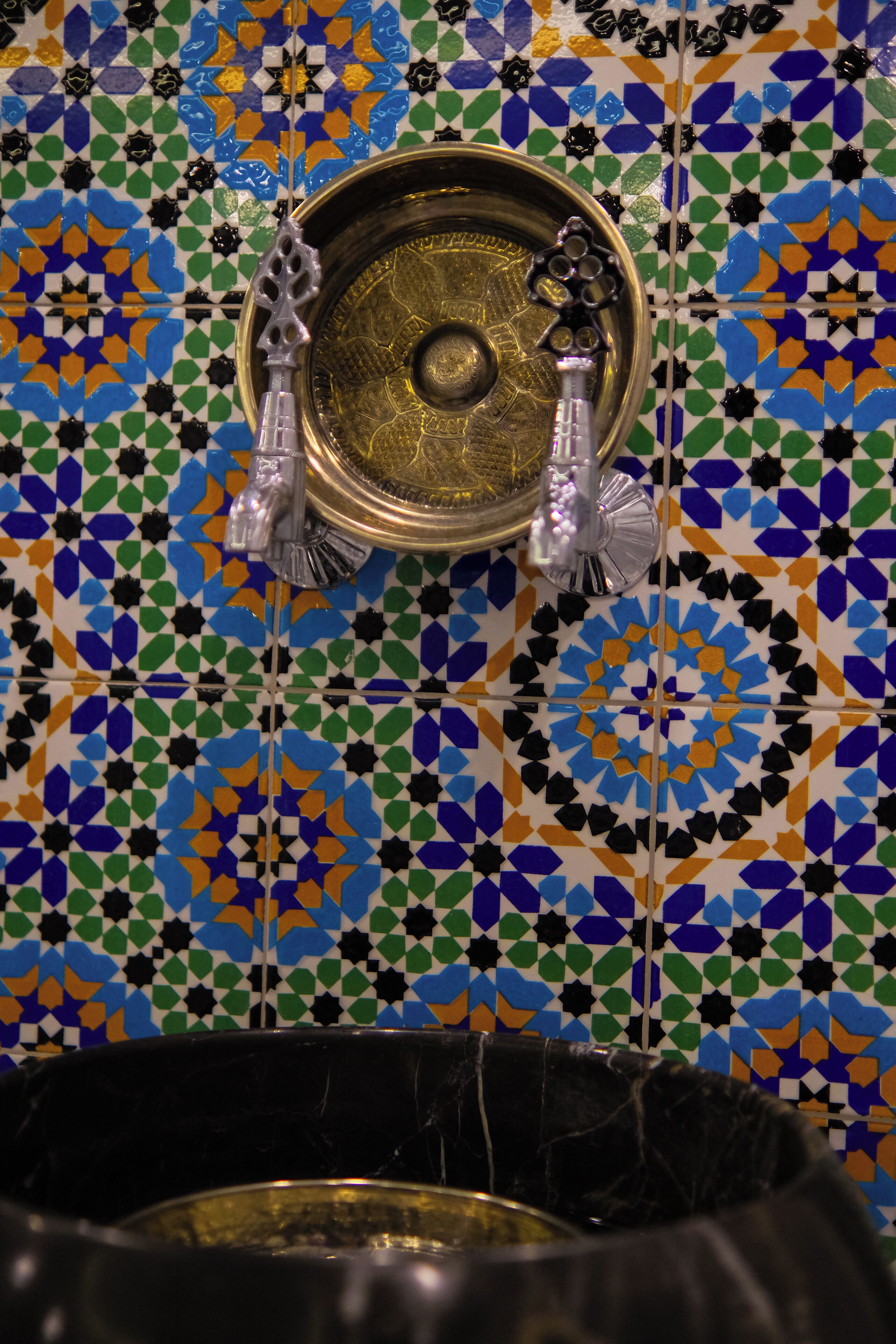 A tiled wall with a geometric pattern.