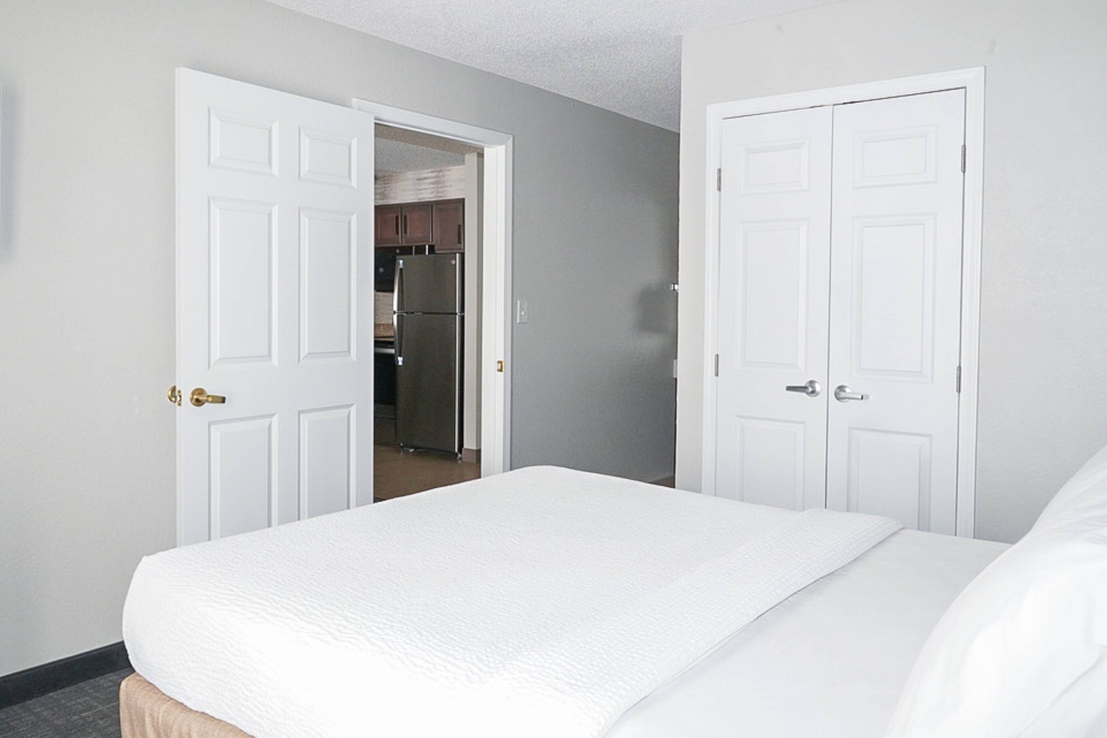 Premium bedding, desk, laptop workspace, blackout drapes