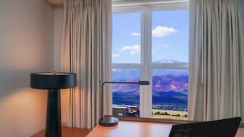 Premium bedding, desk, laptop workspace, blackout drapes