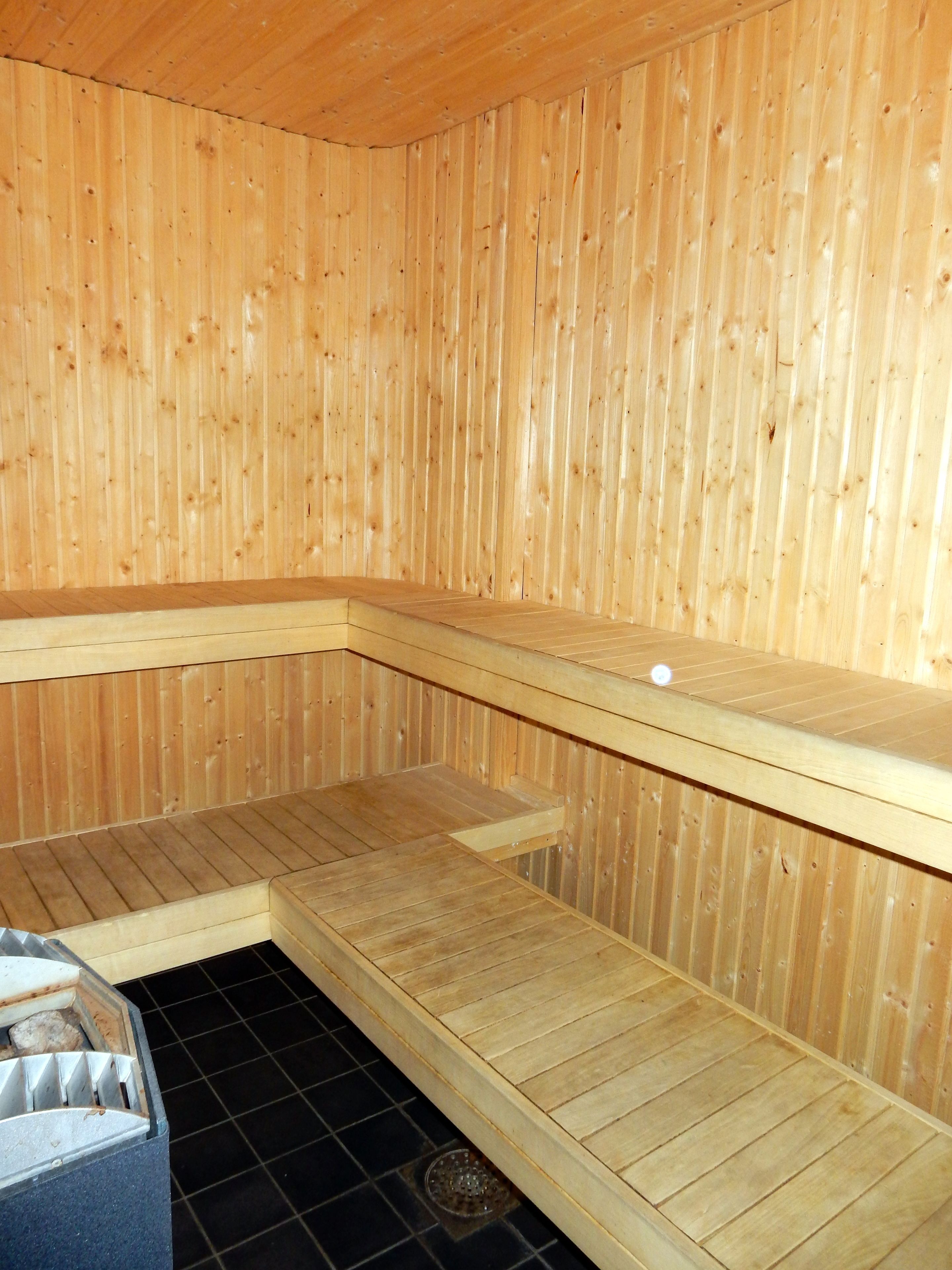 A sauna with wooden walls and benches.