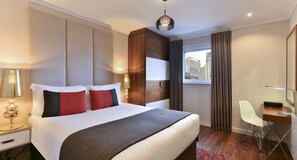 Deluxe Room, 1 Bedroom | 1 bedroom, in-room safe, blackout drapes, iron/ironing board