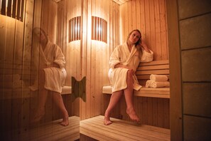 A wooden sauna with benches and towels.