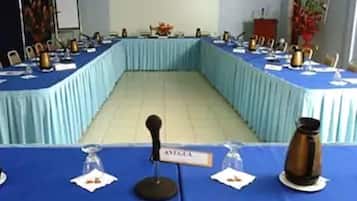 A conference room with a long table, nameplates, microphones, and name tags.