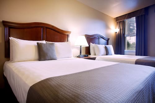 Premium bedding, desk, laptop workspace, blackout curtains