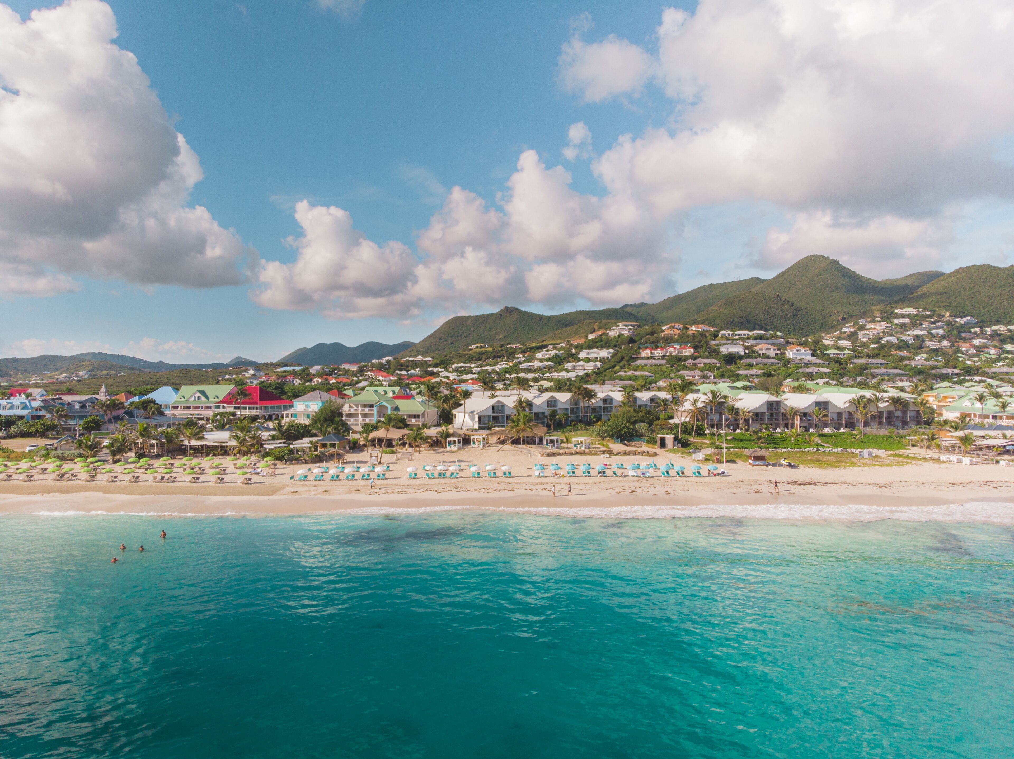 A coastal resort with beachside villas and a sandy beach.