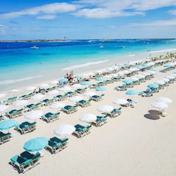 On the beach, white sand, sun-loungers, beach umbrellas