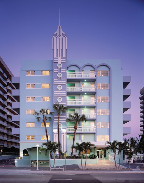 A multi-story hotel with balconies, palm trees, and a modern architectural design. - Solara Surfside (Surfside)