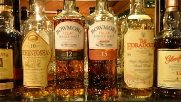 A variety of whisky bottles on a shelf.