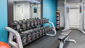 A gym with a bench, dumbbells, and exercise balls. - Hampton Inn Boston Bedford Burlington (Billerica)