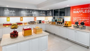 A breakfast buffet with various food items and a chalkboard menu. - Hampton Inn Boston Bedford Burlington (Billerica)