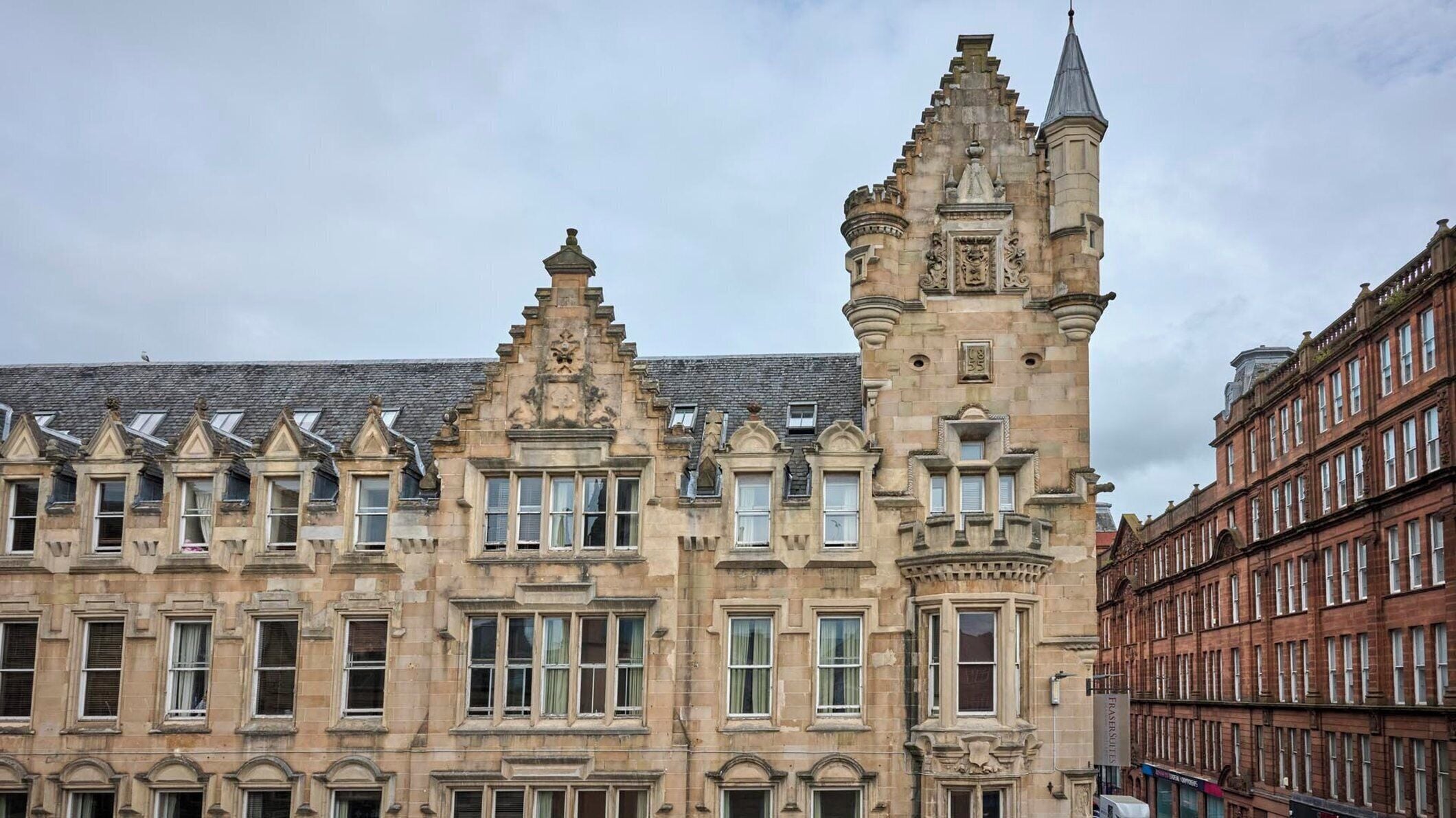 A historic building with ornate architectural details, including a prominent tower and multiple windows.