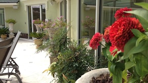 A patio area with potted plants and a table.