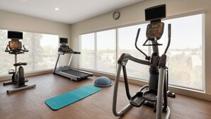 A gym with cardio machines, a treadmill, and a rowing machine. - Holiday Inn Express West Sacramento by IHG (West Sacramento)