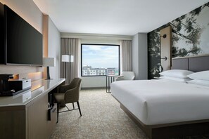 Premium bedding, desk, laptop workspace, blackout drapes