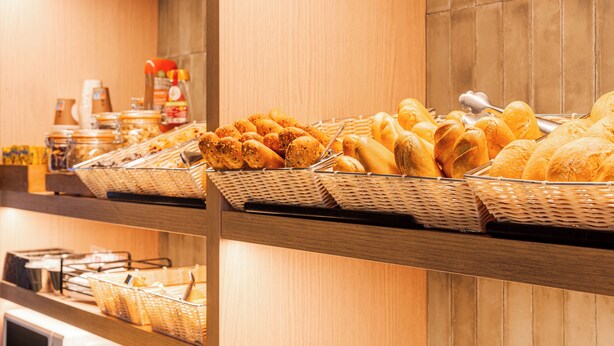 A buffet with various breads and pastries on display. - B&B Hotel Castellon (Castelló de la Plana)