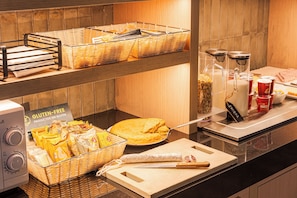 A buffet area with gluten-free products, a pie, and various condiments. - B&B Hotel Castellon (Castelló de la Plana)