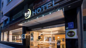 A hotel entrance with a glass facade, a reception desk, and a visible interior seating area. - B&B Hotel Castellon (Castelló de la Plana)