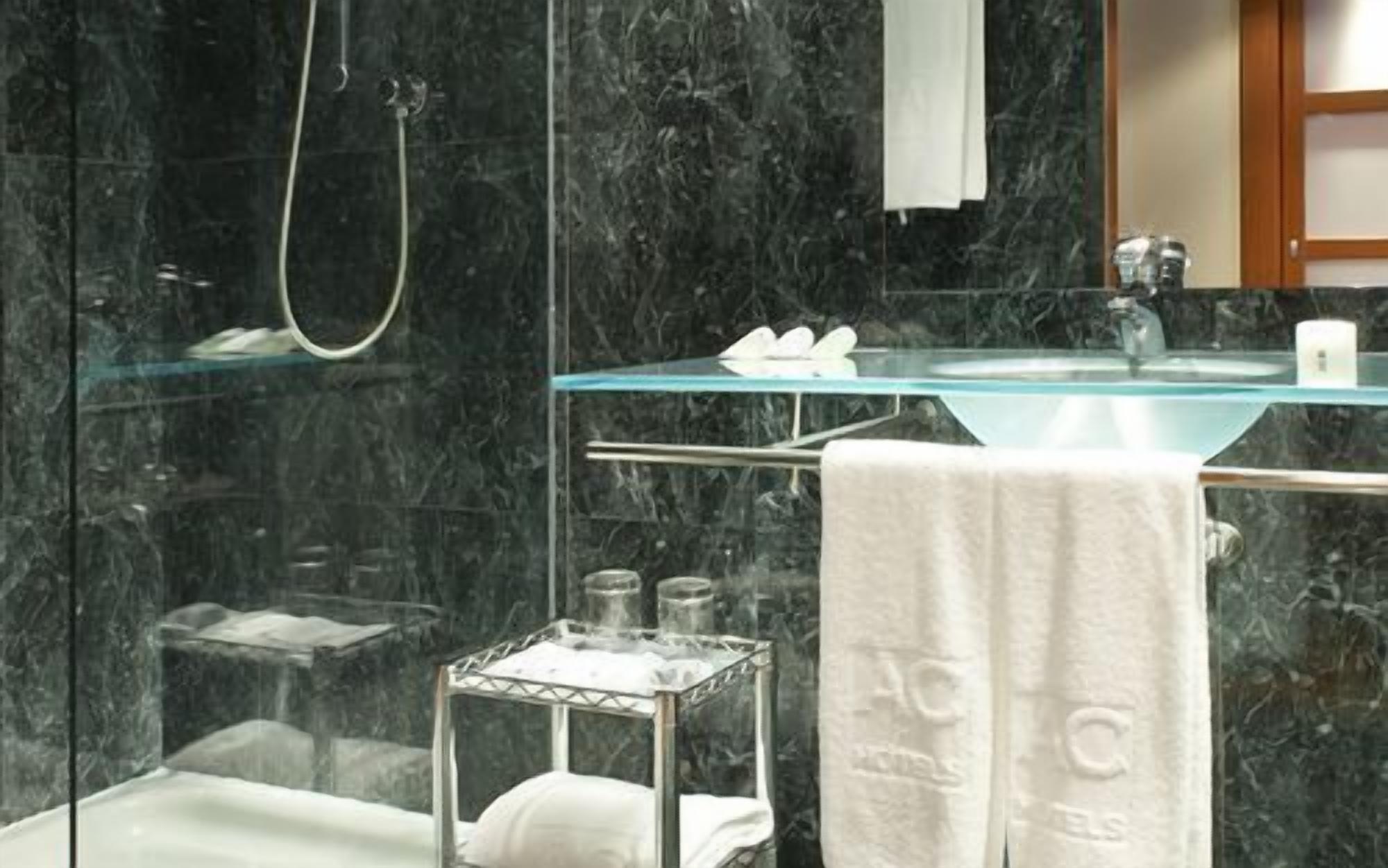 Shower, designer toiletries, hair dryer, towels