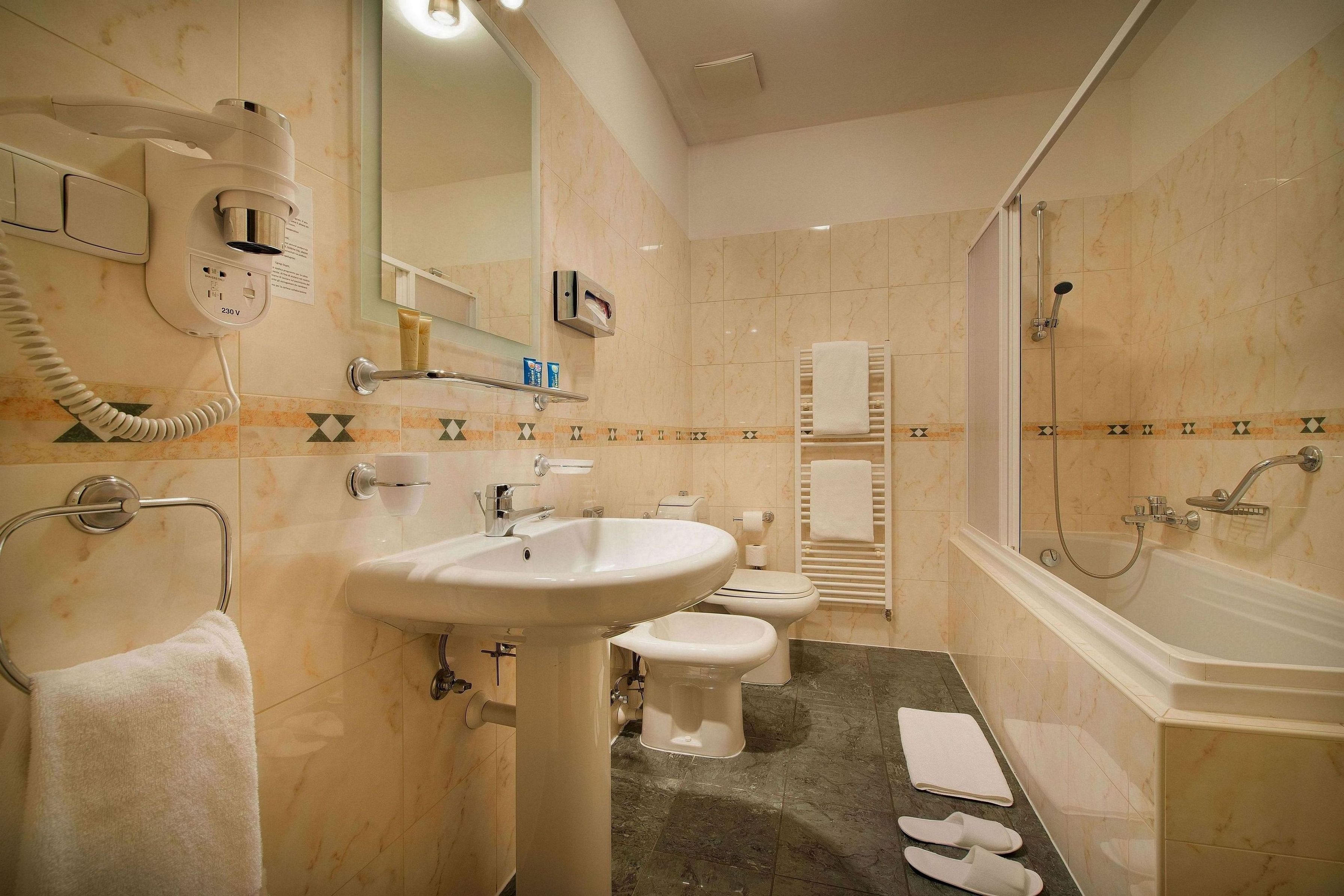 deluxe suite | bathroom | designer toiletries, hair dryer, bathrobes, slippers