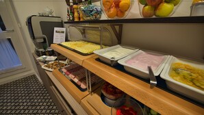 A buffet with various food items including fruits, vegetables, and prepared dishes. - Hotel Suite Home Prague (Prague)