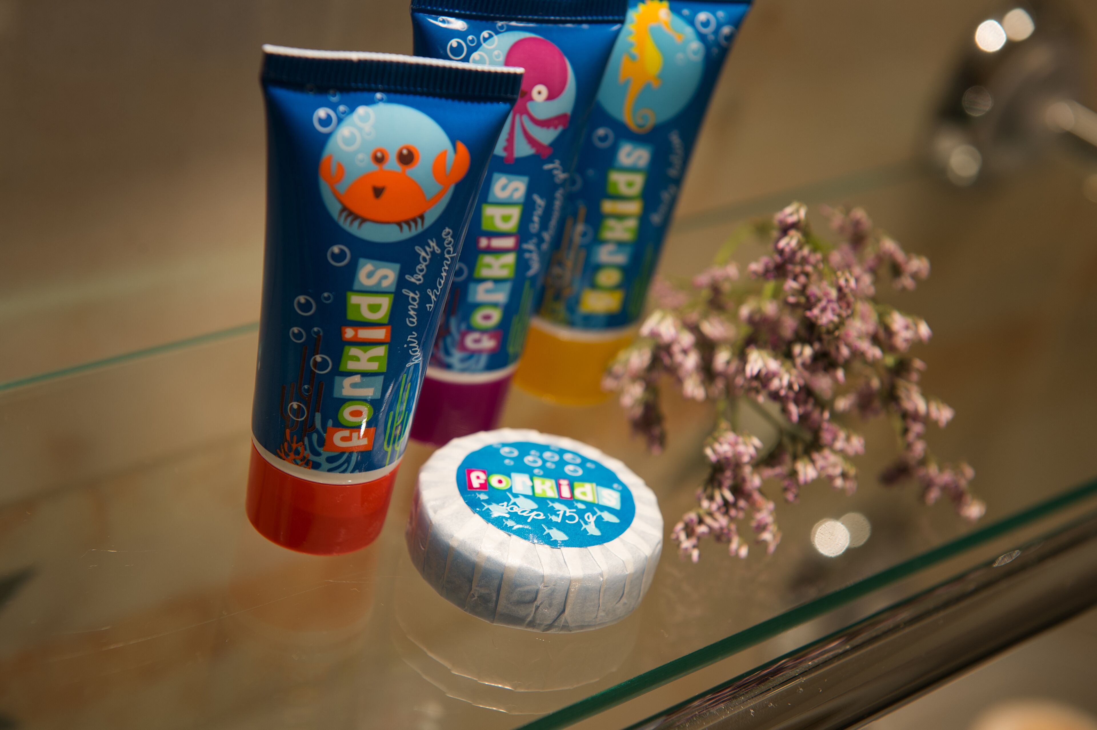 designer toiletries, hair dryer, bathrobes, slippers