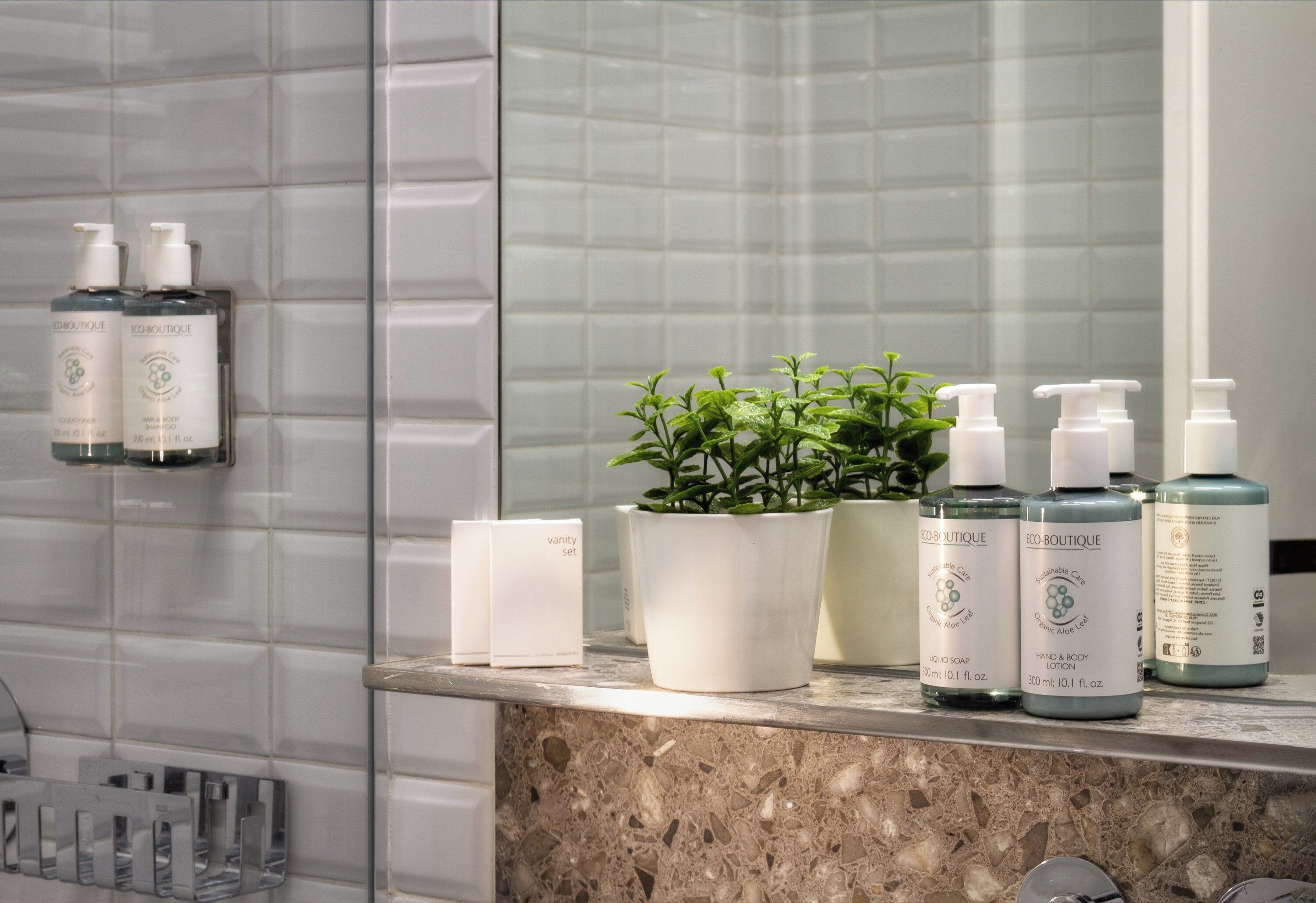 designer toiletries, hair dryer, towels