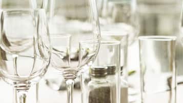 A table with various glassware, including wine glasses and a salt shaker, suggesting a dining setting.