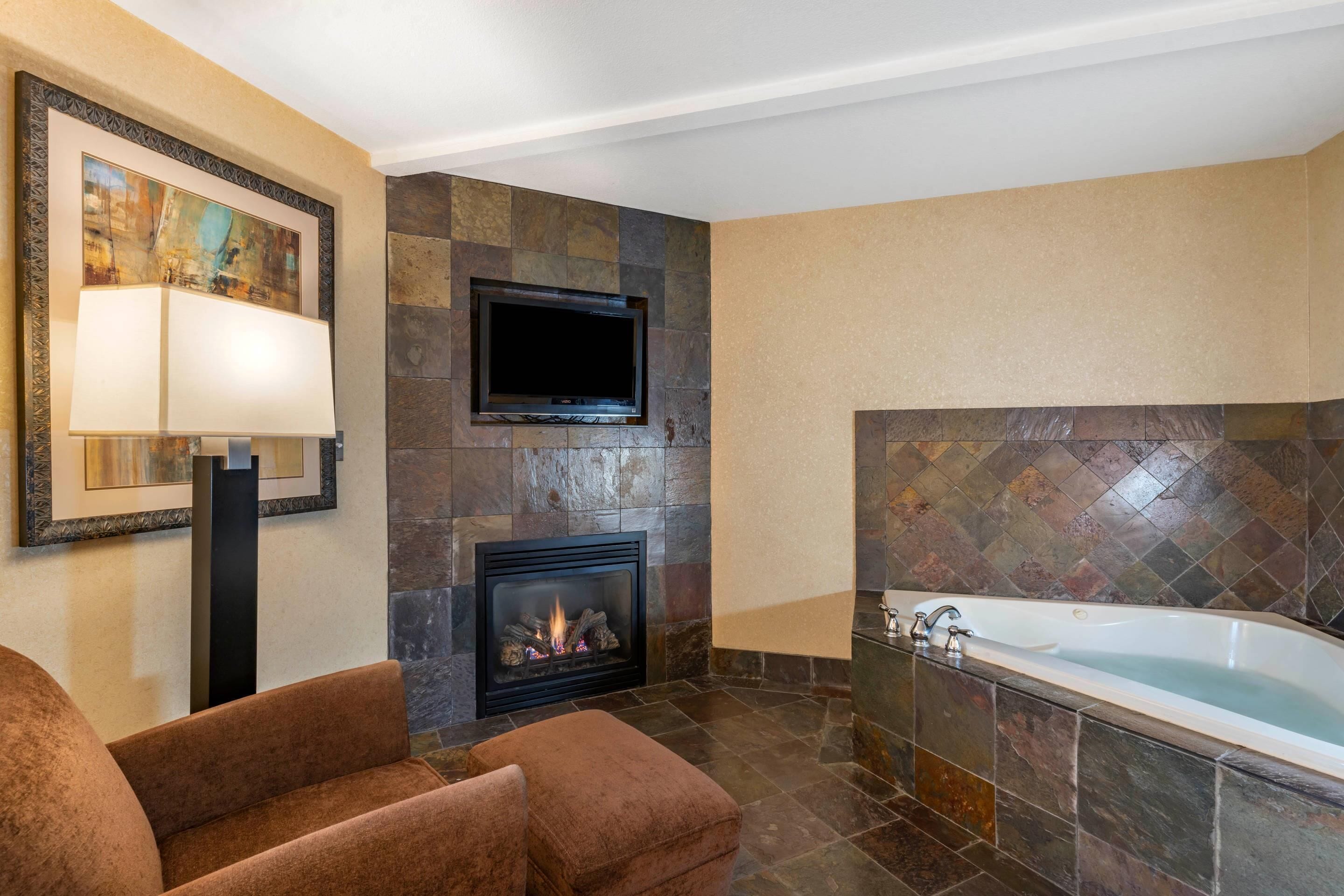 Suite, 1 King Bed, Non Smoking, Fireplace (Adults Only Whirlpool) | Desk, laptop workspace, blackout curtains, iron/ironing board