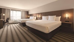 A hotel room with two beds, a desk, and a chair. - Country Inn & Suites by Radisson, Billings, MT (Billings)