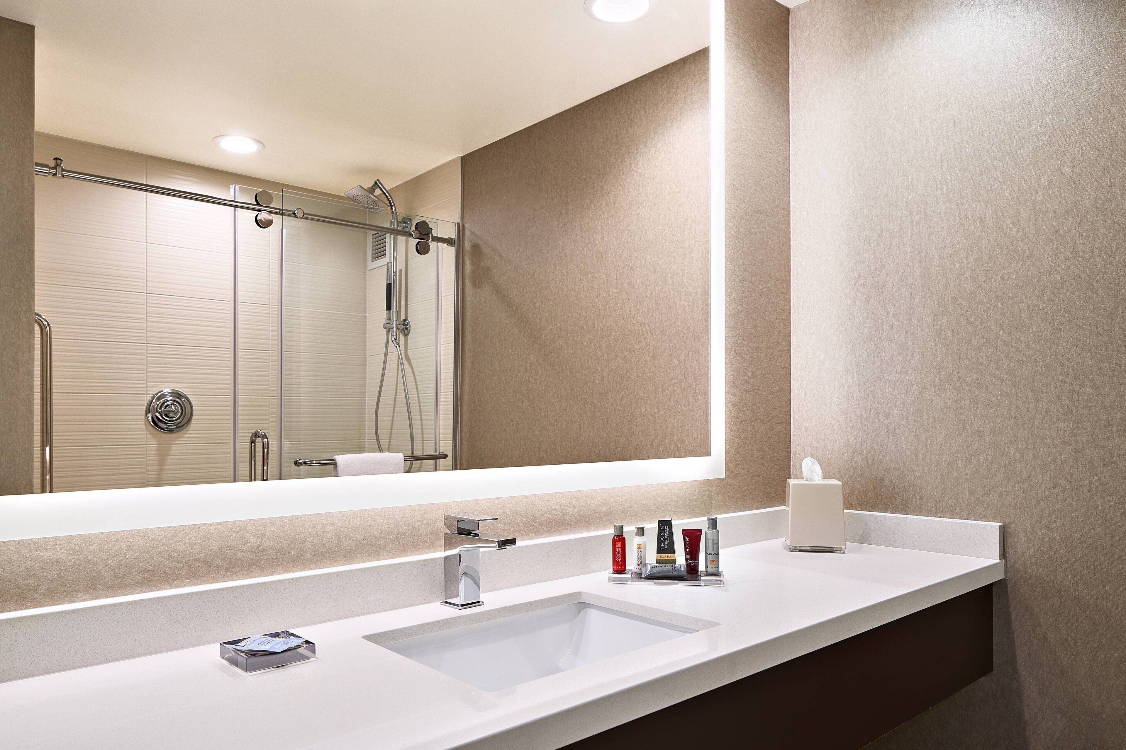 designer toiletries, hair dryer, towels