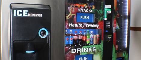 A vending machine with an ice dispenser and a section for snacks and drinks.