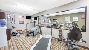 A gym with a treadmill, stationary bikes, and various exercise equipment. - Super 8 by Wyndham Wytheville (Wytheville)