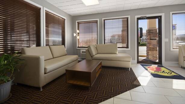 A modern lobby with two sofas, a coffee table, and a patterned rug. - Super 8 by Wyndham Wytheville (Wytheville)