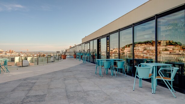 Une terrasse sur le toit, dotée d’un espace extérieur aménagé et offrant une vue sur la ville.